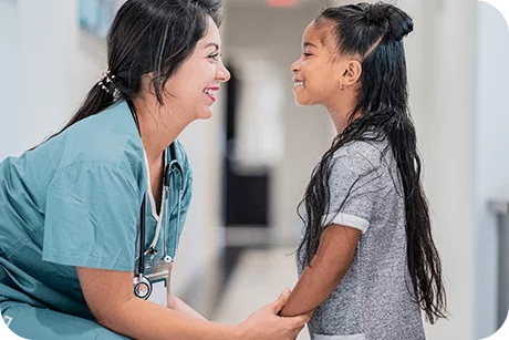 Smiling pediatric nurse with patient